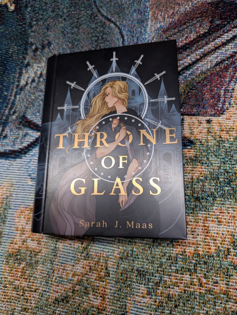 Image of a tin with art for Throne of Glass by Sarah J. Mass on it